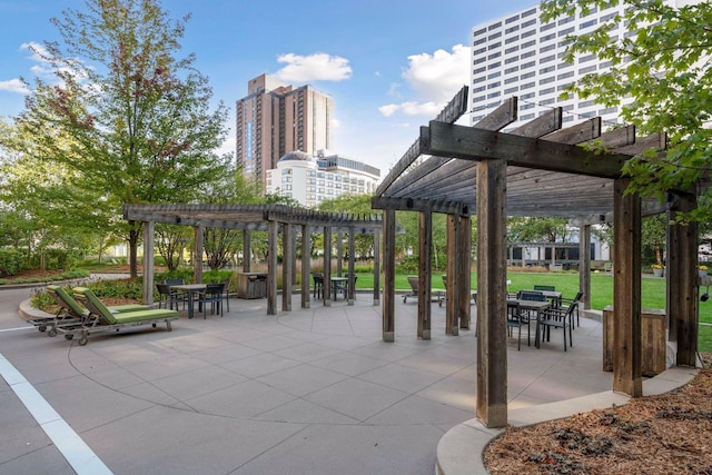 view of community with a yard, a patio area, and a pergola