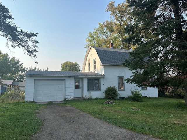 view of front of house with a front lawn and a garage