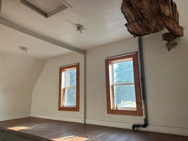 additional living space featuring dark hardwood / wood-style flooring and lofted ceiling