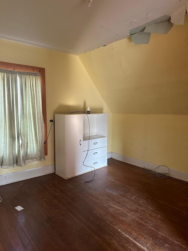 additional living space with lofted ceiling and dark wood-type flooring