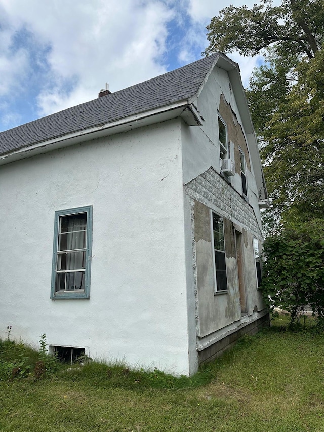 view of home's exterior with a lawn