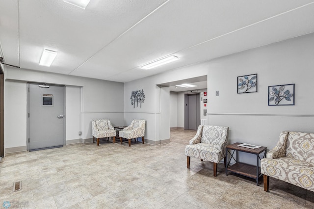 sitting room featuring baseboards and visible vents