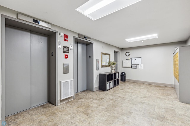 interior space with elevator, baseboards, visible vents, and tile patterned floors