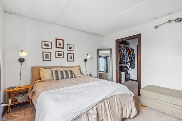 carpeted bedroom with a closet and a spacious closet