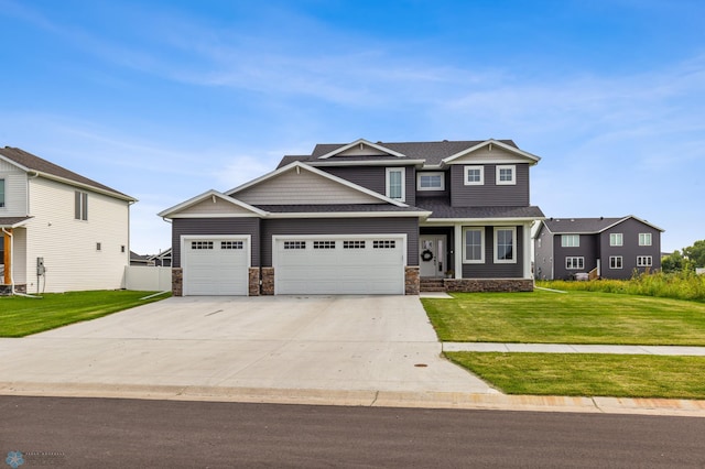 craftsman house featuring stone siding, roof with shingles, concrete driveway, a front yard, and a garage