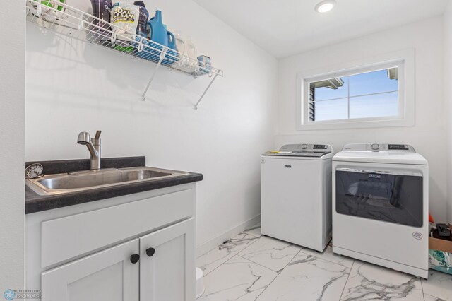 washroom featuring cabinets, independent washer and dryer, and sink