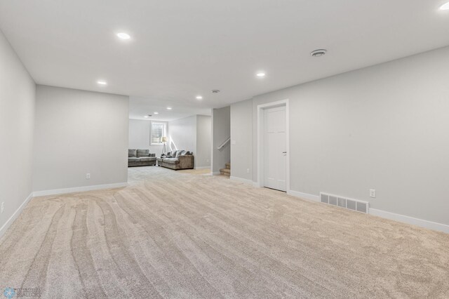 unfurnished living room with light colored carpet