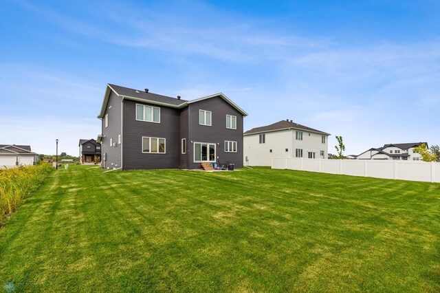 back of house featuring a lawn