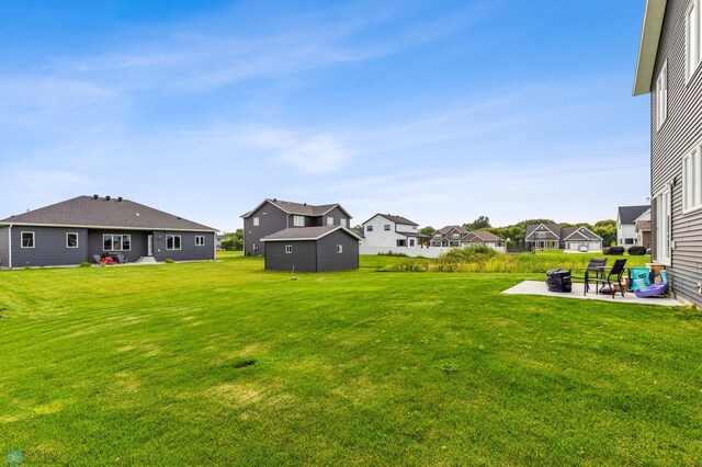 view of yard featuring an outdoor structure and a patio