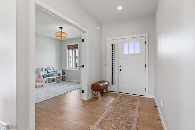 entrance foyer featuring wood-type flooring and a notable chandelier