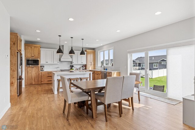 dining space featuring sink and light hardwood / wood-style floors