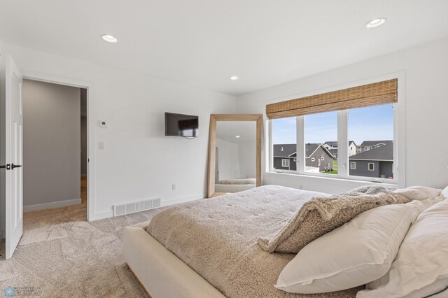 bedroom featuring light carpet