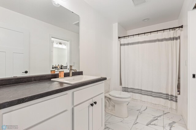 bathroom featuring vanity, toilet, and a shower with curtain