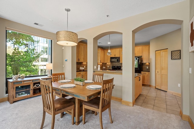 dining area with light colored carpet