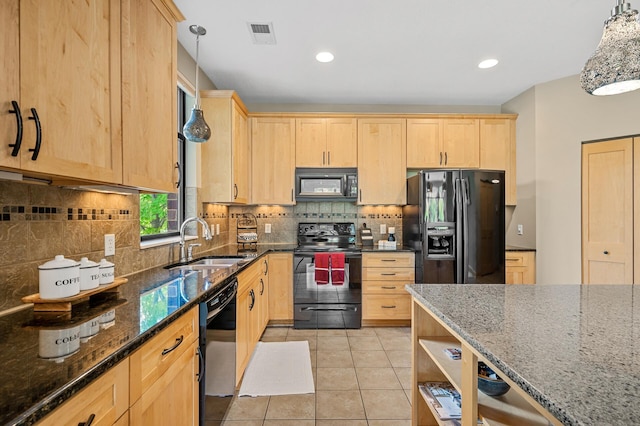 kitchen featuring black appliances, sink, light brown cabinets, and hanging light fixtures