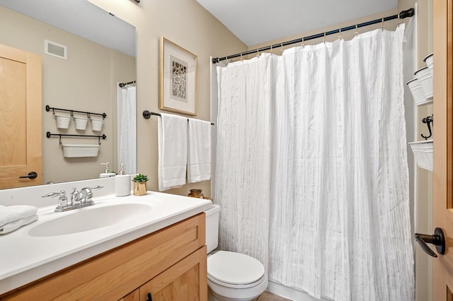 bathroom with vanity, toilet, and curtained shower