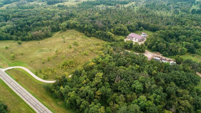 birds eye view of property with a view of trees