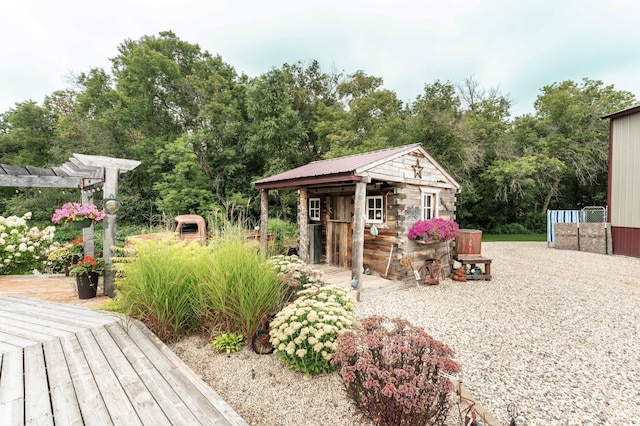 exterior space with an outbuilding and a pergola