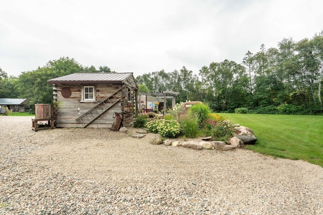 exterior space with metal roof and a lawn