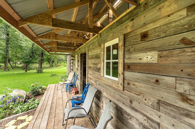 wooden terrace featuring a yard