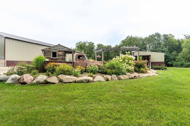 view of yard featuring an outbuilding and a pergola