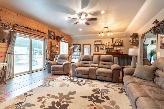 living room with wooden walls and a ceiling fan