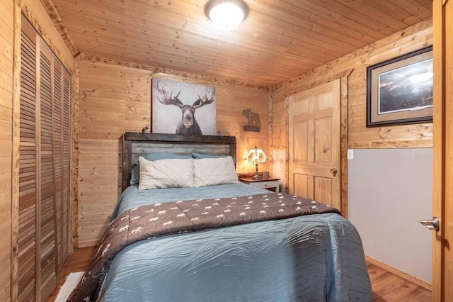 unfurnished bedroom with wood walls, wooden ceiling, and wood finished floors