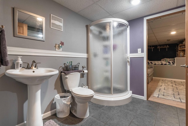 full bath featuring a drop ceiling, a stall shower, toilet, and visible vents