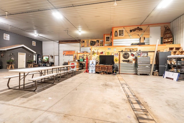 garage with a workshop area and metal wall