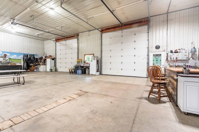 garage with a workshop area and metal wall