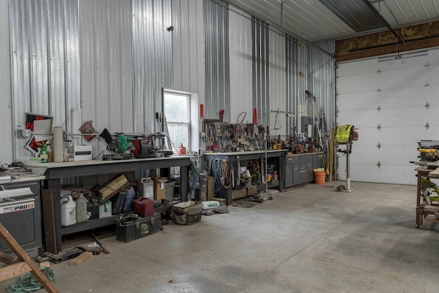 garage featuring a workshop area and metal wall