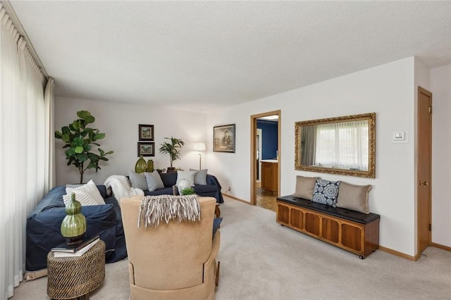 carpeted living room featuring a textured ceiling