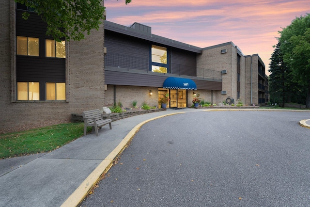 view of outdoor building at dusk