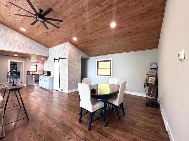 dining room featuring wooden ceiling, a barn door, baseboards, and dark wood-style flooring