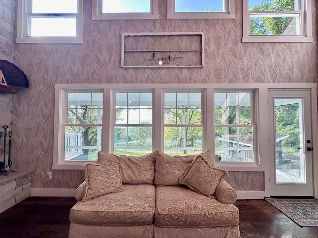 living room with baseboards, dark wood finished floors, and wallpapered walls