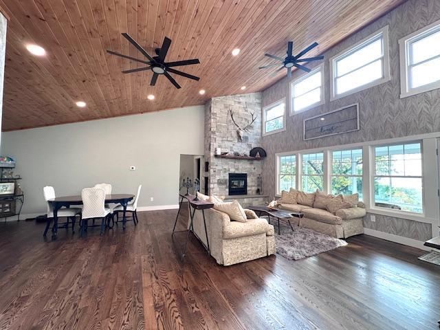 living room with dark wood-style floors, a fireplace, recessed lighting, high vaulted ceiling, and wooden ceiling