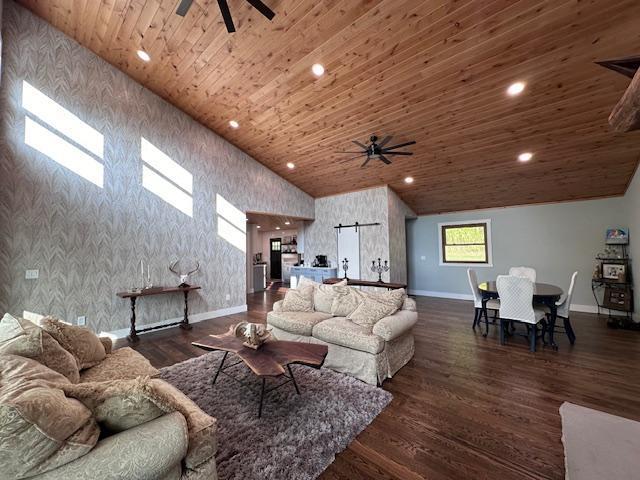 living area featuring dark wood-type flooring, wood ceiling, and ceiling fan