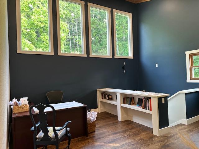 office area with dark wood-style floors and baseboards