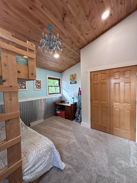 bedroom with a chandelier, wooden ceiling, carpet flooring, and vaulted ceiling