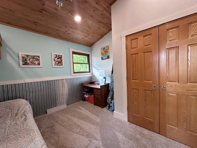 carpeted bedroom with lofted ceiling, a wainscoted wall, wood ceiling, and wood walls