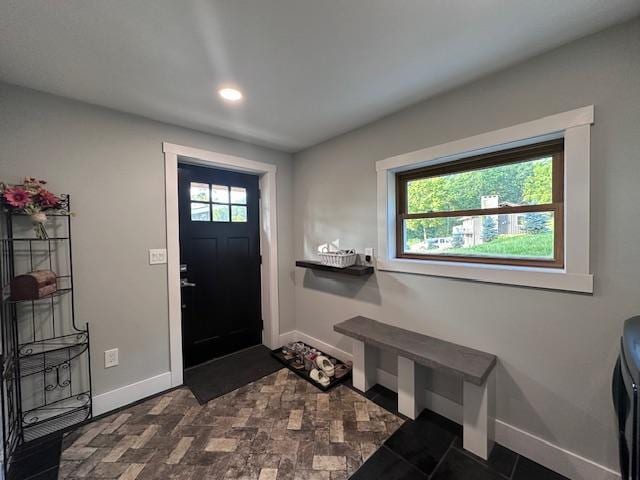 foyer entrance with a healthy amount of sunlight and baseboards