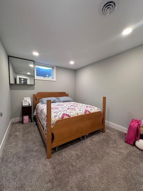 bedroom featuring dark colored carpet, visible vents, baseboards, and recessed lighting