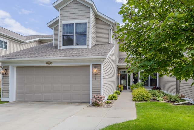 view of front of home featuring a garage and a front lawn