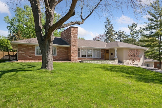 rear view of house with a chimney and brick siding