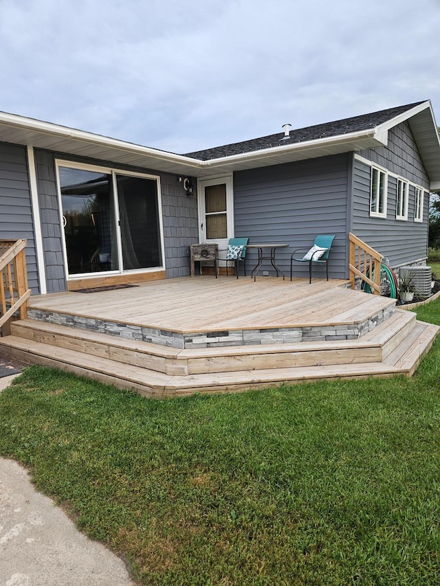 exterior space with a lawn and a wooden deck