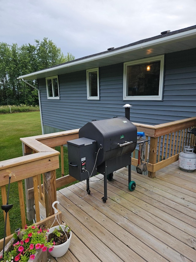 wooden terrace with grilling area and a yard