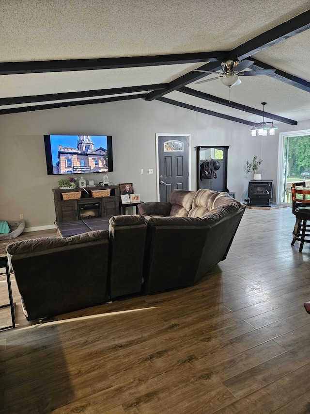 living room with vaulted ceiling with beams, a ceiling fan, a textured ceiling, and wood finished floors