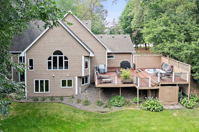 rear view of property featuring a deck and a lawn