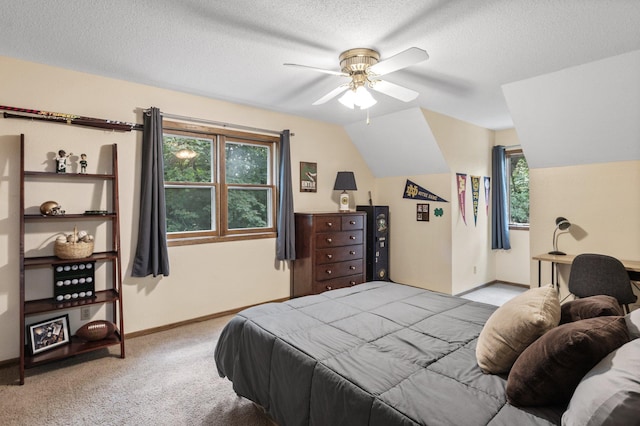 bedroom featuring a textured ceiling, ceiling fan, vaulted ceiling, and light colored carpet