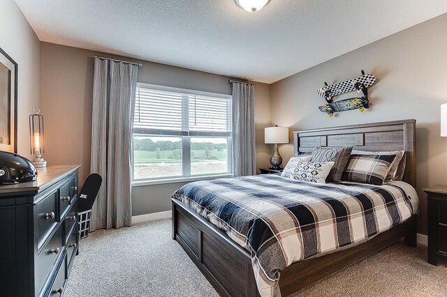 carpeted bedroom with a textured ceiling